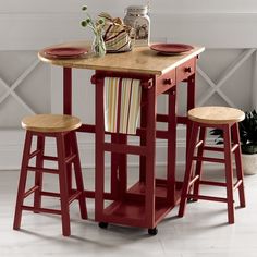 a small kitchen table with stools on it