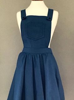 "A gorgeous cute pinafore dress made from a medium weight denim fabric in a medium blue.  The pinafore has a bib with pocket detailing, shoulder straps, waistband, full skirt and a back zip fastener.  The pinafore looks perfect worn with a polo neck jumper for the colder months, or wear with  a T-shirt in the warmer seasons.  XS - (6-8). Bust 31-32\".  Waist 22-23\".  Hips 32-34\"  S  -  (8-10). Bust 34-55\".  Waist 24-26\". Hips 35-37\"  M  -  (12-14). Bust 37-38\".  Waist 27-29\". Hips 38-40\" Blue Dungarees, Checked Shirt Dress, Sabrina Dress, Dungaree Dress, Casual Day Outfits, Full Circle Skirts, Pinafore Dress, Polo Neck, Dress Zipper