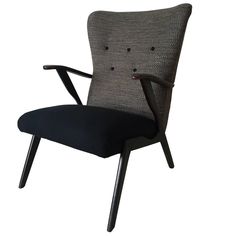 an upholstered chair with black fabric and wooden legs, on a white background