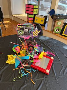 a table topped with lots of colorful items on top of a black cloth covered table