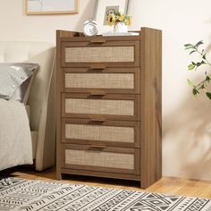 a bedroom with a bed, dresser and pictures on the wall