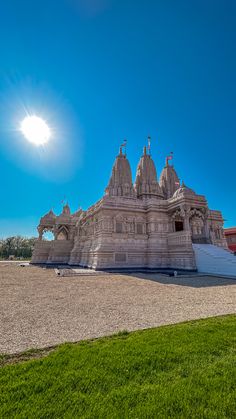 the sun shines brightly over an ornately designed temple on a sunny day in india