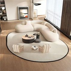 a modern living room with white furniture and wood flooring