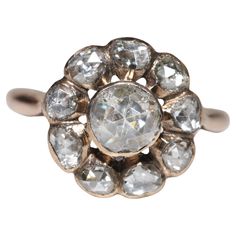 an antique diamond cluster ring in yellow gold