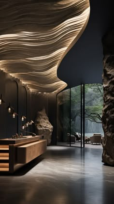 the interior of a modern building with large rocks and wooden tables in front of it