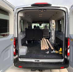 the back end of a van with wood pieces in it's cargo door and seats folded down