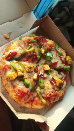 there is a pizza in the box with toppings on it, ready to be eaten