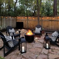 an outdoor fire pit with chairs around it