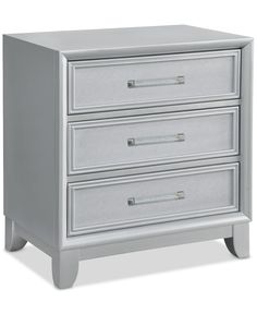 a white nightstand with three drawers on it