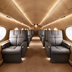 the inside of an airplane with several seats and two windows on each side of the plane