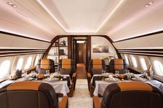 the inside of an airplane with several tables and chairs set up for two people to eat