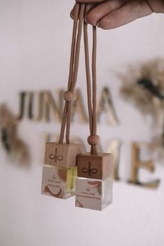 two small wooden tags hanging from strings