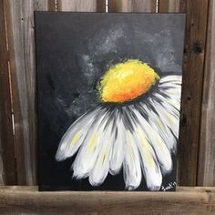 a painting of a white and yellow flower on a black background with wood planks