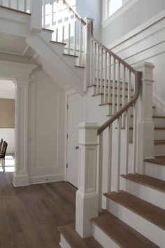 the stairs in this house are white and wood