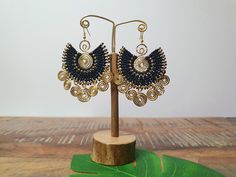 So statement, so simple! So Egyptian queen. We have created these absolutely stunning black macramé gold spiral earrings for you, go no further than these showstopping, versatile beauties! Intricate black macrame adorns hammered brass wire, which has been graced by suspended golden spirals, also with a hammered metal patina. For pierced ears, these boho earrings have been lovingly handmade from nickel-free brass wire and skillfully woven waxed cotton which is strong and water-proof. Please do sw Black Handwoven Jewelry For The Beach, Black Handwoven Jewelry For Beach, Handwoven Black Jewelry For The Beach, Gold Wire Wrapped Earrings For Festival, Gold Macrame Earrings For Festival, Gold Macrame Earrings, Black Bohemian Brass Earrings, Bohemian Black Brass Earrings, Metal Patina