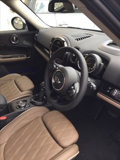 the interior of a car with tan leather seats