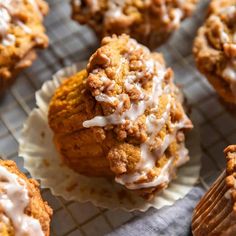 muffins with white icing on a cooling rack