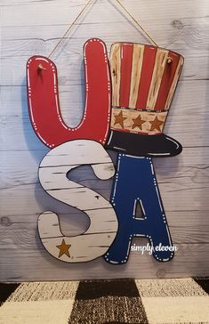 a wooden sign that says usa with a top hat and the word usa on it