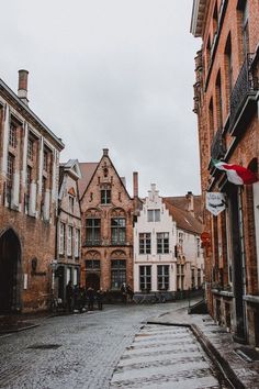 an empty cobblestone street lined with old buildings