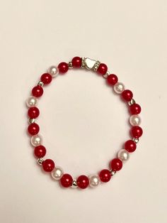 A bracelet with red and white pearls and silver details. Beaded on an elastic thread.  The perfect accessory to complete your festive look for the holidays 🌟❤️🎄 ----------- 💗All our jewelry is handmade with love. The elastic bracelets are stretchy. Kids normally have a size between 12 - 15 centimeters, and adults 16-20 centimeters. Of course this may vary. To make sure your new bracelet fits, measure your wrist with a string etc. Centimeters to inches conversion guide: 12 cm- 4.72 inches 13 cm- 5.1 inches 14 cm- 5.5 inches 15 cm- 5.9 inches 16 cm- 6.29 inches 17 cm- 6.69 inches 18 cm- 7.1 inches 19 cm- 7.5 inches 20 cm- 7.87 inches 💗While we strive to make each piece of jewelry in one option identical to the picture, some beads may differ.  How to take care of your bracelet  🌟Painted Red Bracelet Ideas, Bracelets Red, Diy Kandi Bracelets, Red Beaded Bracelet, Stack Bracelets, Elastic Bracelets, Stack Bracelet, Silver Heart Bracelet, New Bracelet