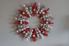 a wreath made out of red and white pins