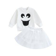 a white sweater and tutu skirt outfit with black eyes on the front, one eye is