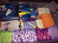 an open plastic container filled with different types of diapers and other medical care items