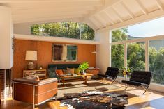 a living room filled with furniture and lots of windows