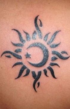 a sun tattoo on the back of a woman's upper arm, with black ink