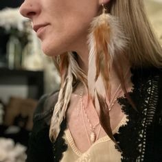 a woman with long blonde hair wearing earrings