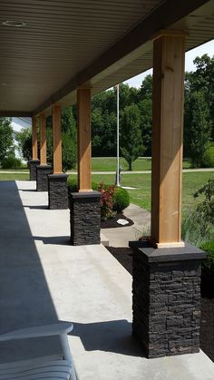 an outdoor covered walkway with benches and chairs