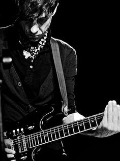 a man playing an electric guitar on stage