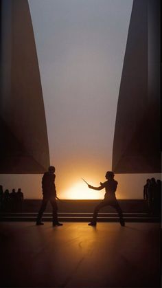 two people are dancing in front of the sun