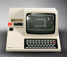 an old computer with a tennis game on it's screen and keyboard, in front of a gray background