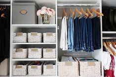 an organized closet with clothes and baskets