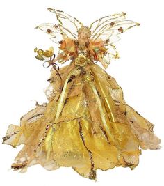 a gold fairy doll with golden wings and flowers on it's head, standing in front of a white background