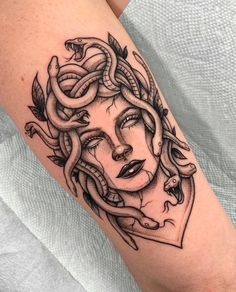 a woman's face with snakes on her arm