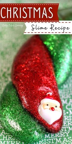 a santa clause ornament sitting on top of green glitter