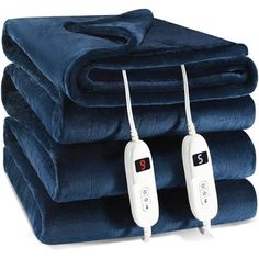 three electric heated blankets stacked on top of each other with two remotes attached to them