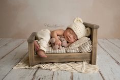 a newborn baby is sleeping in a wooden crate