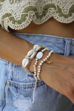 Two gold and white beaded bracelet. Features a gold shell charm. All Lauren Nicole jewelry is nickel compliant. This item is Final Sale. Surf Bracelets, Cowgirl Bracelets, White Beaded Bracelet, Country Thunder, Beachy Bracelets, Lauren Nicole, Cowry Shell, Heel Accessories, Brown Bracelet