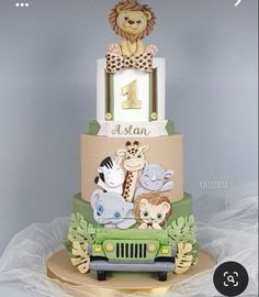 a three tiered cake with animals on it