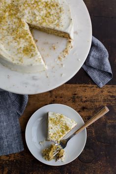 a piece of cake on a plate with a fork next to it and another slice missing