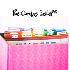 a pink box filled with files and folders next to the words the sunday basket