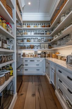 an open pantry with lots of shelves and jars on the wall, along with wooden flooring