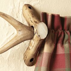 the antlers are hanging on the wall next to the plaid blanket and pillow cover