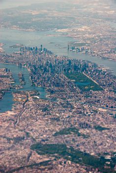 an aerial view of new york city and the hudson river, taken from an airplane