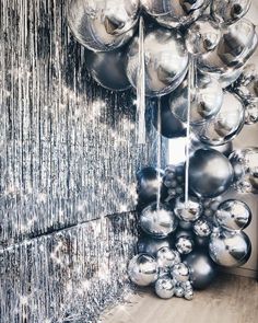 a bunch of silver balls hanging from the ceiling