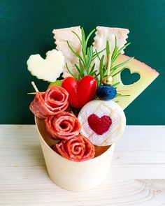 a cup filled with food on top of a table