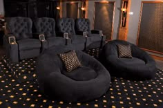 a room filled with black chairs and gold stars on the carpeted floor next to a wall